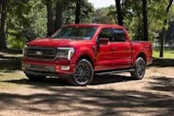 Red F-150 with trees in background